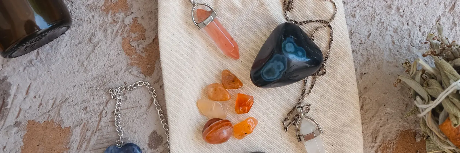 Péndulos, cristales y hierbas sobre una mesa
